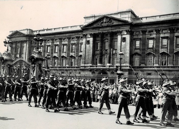 A group of people marching in front of a building

Description automatically generated with medium confidence