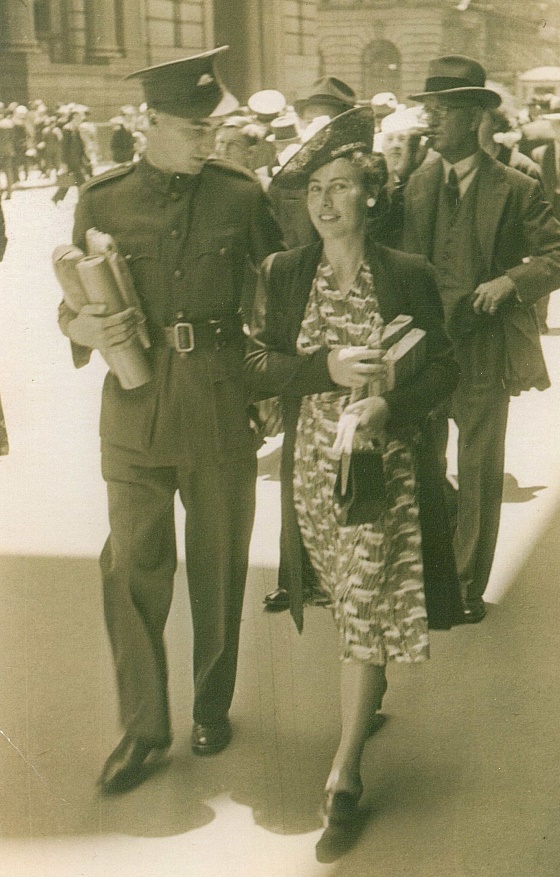 A person in a dress standing next to a person in a uniform

Description automatically generated with low confidence